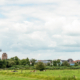 Zicht op Beesd met Molen de Vrijheid, St. Pieterskerk of Petruskerk en Kerk H. Kruisverheffing